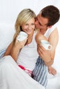 Couple in bed drinking coffee with affection Royalty Free Stock Photo