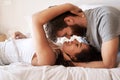 Couple, bed and embrace with face, smile and together in morning for romance, love and bonding in home. Young man, woman Royalty Free Stock Photo