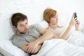 Couple in bed husband frustrated upset and unsatisfied while his internet couple in bed husband frustrated upset unsatisfied while Royalty Free Stock Photo