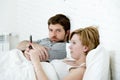 couple in bed husband frustrated upset unsatisfied while wife using mobile phone Royalty Free Stock Photo