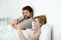 couple in bed husband frustrated upset unsatisfied while wife using mobile phone Royalty Free Stock Photo