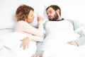 Couple in bed. Man snoring and woman can`t sleep