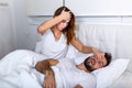 Couple in bed, man snoring and woman can`t sleep. Snoring man and young woman. Couple sleeping in bed. Young girl can`t sleep