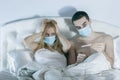 Couple in bed suffering common cold