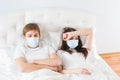 Couple in bed suffering common cold