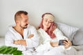 Couple on bed take photo on smartphone Royalty Free Stock Photo