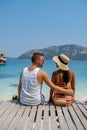 Couple from behind on the backside looking out over ocean of tropical Island, beautiful tropical island beach - Koh Kham Royalty Free Stock Photo