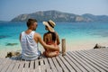 Couple from behind on the backside looking out over ocean of tropical Island, beautiful tropical island beach - Koh Kham Royalty Free Stock Photo