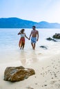 Couple from behind on the backside looking out over ocean of tropical Island, beautiful tropical island beach - Koh Kham Royalty Free Stock Photo