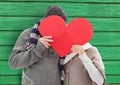couple behind the heart with green wood background Royalty Free Stock Photo