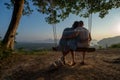 Couple on the bench over beautiful tropical mountain landscape