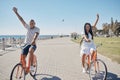 Couple, bicycle and celebrate happiness for freedom on beach, travel holiday and summer vacation. Happy man, woman smile