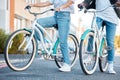 Couple, bicycle and legs in the street of a city for travel, exercise or adventure in the outdoors. Interracial man and