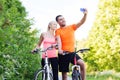 Couple with bicycle taking selfie by smartphone Royalty Free Stock Photo