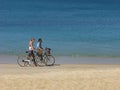 Man and woman with bicycles on sea beach