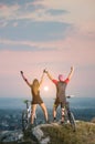 Couple bicyclist with mountain bikes on the hill at sunset Royalty Free Stock Photo