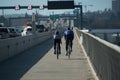 A couple of bicyclists ride from Eastside to Seattle on Evergreen Floating Bridge trail