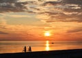 Couple of bicyclists walking along the seashore