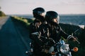 couple of bikers in helmets riding classical motorcycle Royalty Free Stock Photo