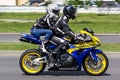 A couple of bikers on a motorcycle rides through the streets of the city of Brest