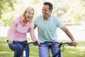 Couple on bikes outdoors smiling Royalty Free Stock Photo