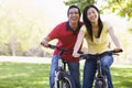 Couple on bikes outdoors smiling Royalty Free Stock Photo