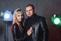 Couple in black dresses during image shooting in studio and spotlights