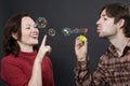 Couple blowing bubbles