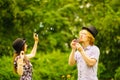 Couple blowing bubbles outdoor Royalty Free Stock Photo