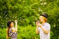 Couple blowing bubbles outdoor Royalty Free Stock Photo