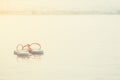 Couple blue and pink sandal on beach