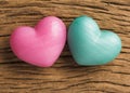 Couple of blue and red heart shapes over wooden table. Valentine Royalty Free Stock Photo