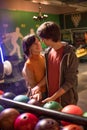 Couple in a bowling alley and holding a ball together Royalty Free Stock Photo