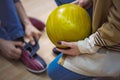 Couple in a bowling alley. Man is wearing bowling shoes. Woman holding a ball Royalty Free Stock Photo