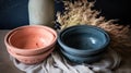 a couple of bowls sitting on top of a table next to a vase