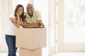 Couple with boxes in new home smiling Royalty Free Stock Photo