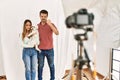 Couple of boyfriend and girlfriend with dog posing as model at photography studio annoyed and frustrated shouting with anger, Royalty Free Stock Photo