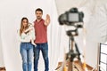 Couple of boyfriend and girlfriend with dog posing as model at photography studio with open hand doing stop sign with serious and Royalty Free Stock Photo