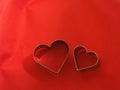 Couple bread molds stainless Heart shaped on fabric red background, love Valentine Day for copy text card, background Royalty Free Stock Photo