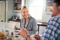 Couple, breakfast and eating while laughing at table, love and care for fiber of meal in home. Happy people, cereal and Royalty Free Stock Photo