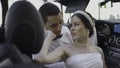 Couple of bride and groom in convertible. Action. Beautiful couple of newlyweds in car in summer. Couple plays newlyweds Royalty Free Stock Photo