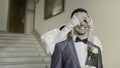 A couple of the bride and groom flirting with each other. Action. Smiling newlyweds filming in a building with bright Royalty Free Stock Photo