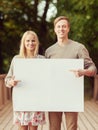 Couple on the bridge with blank white board