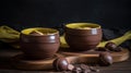 a couple of brown bowls sitting on top of a wooden table