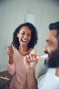 Couple, brushing teeth and laughing in bathroom, happy and love in morning routine, play or funny joke. People, cleaning Royalty Free Stock Photo