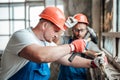 A couple of builders remove old plaster from a brick wall Royalty Free Stock Photo