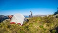 A couple building up a tent in the wilderness in Norway. Royalty Free Stock Photo