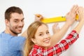 Couple building using spirit level to measure Royalty Free Stock Photo