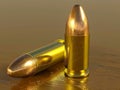A couple of bullets sitting on top of a wooden table Royalty Free Stock Photo