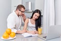 Couple of busy woman and man in morning at kitchen. Royalty Free Stock Photo